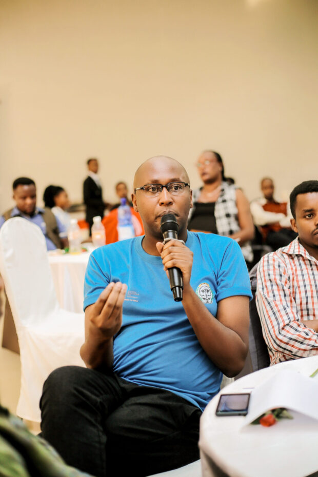 Participant speaking into a microphone.