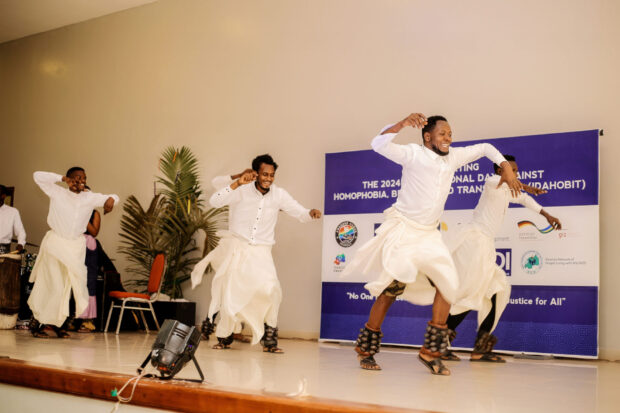 Group performing a traditional dance on stage at an IDAHOBIT 2024 event.