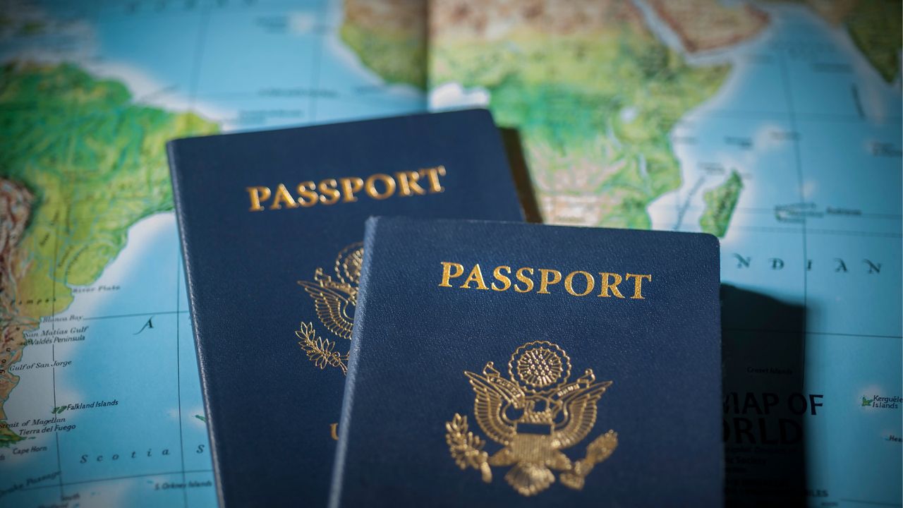 Two passports on top of a world map.