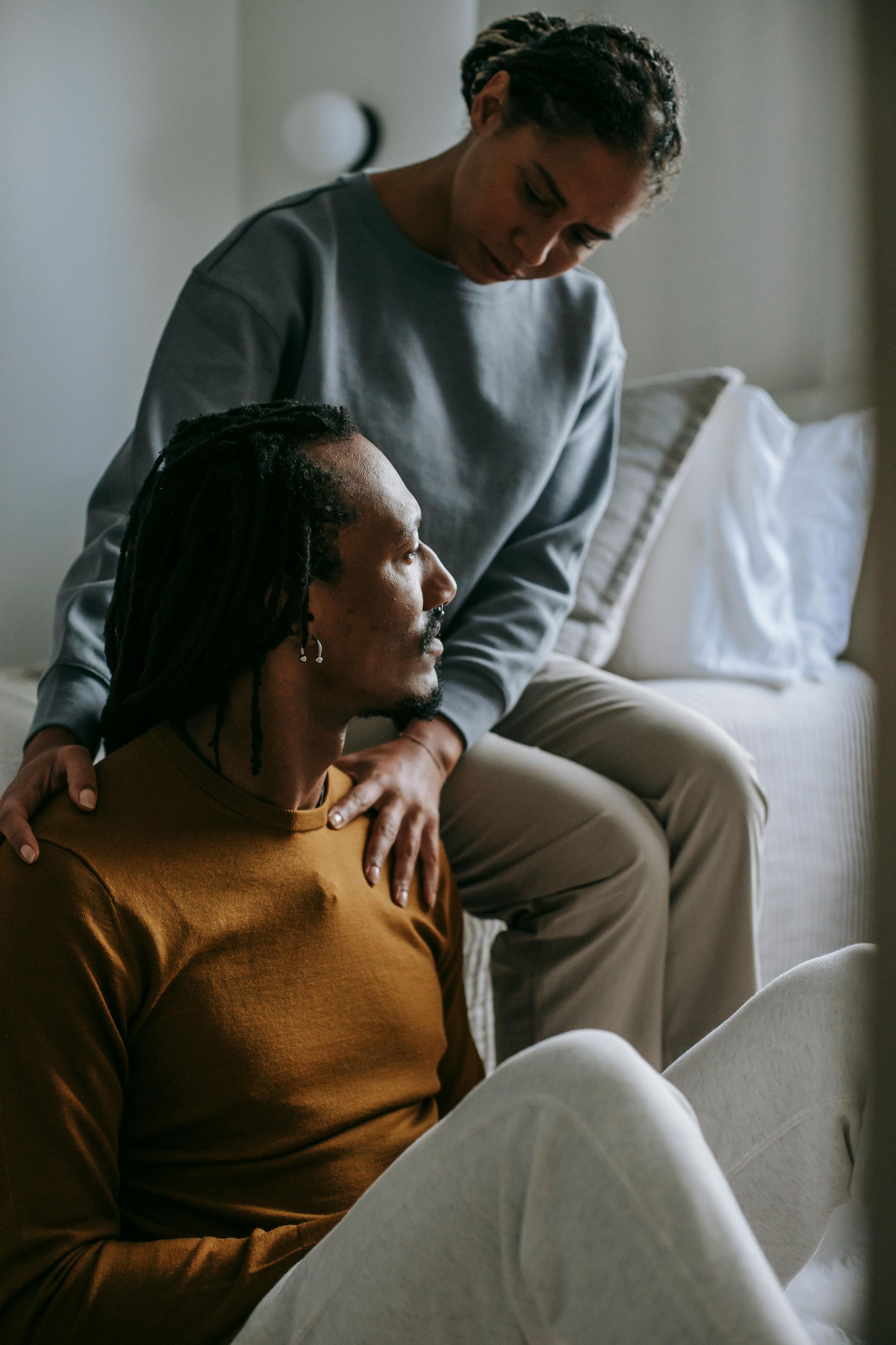 Couple sitting on bed