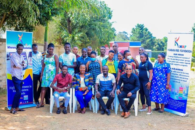 Group of people in colourful clothing with the MRF Banner.