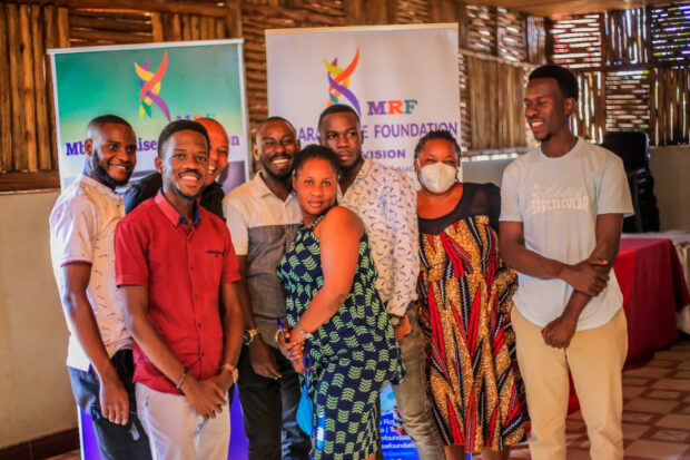 Group of people smiling in front of the MRF Banner.